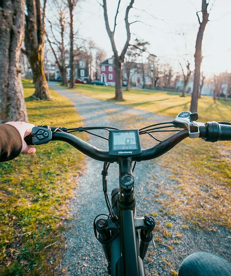 Person Riding Electric Bike on Path